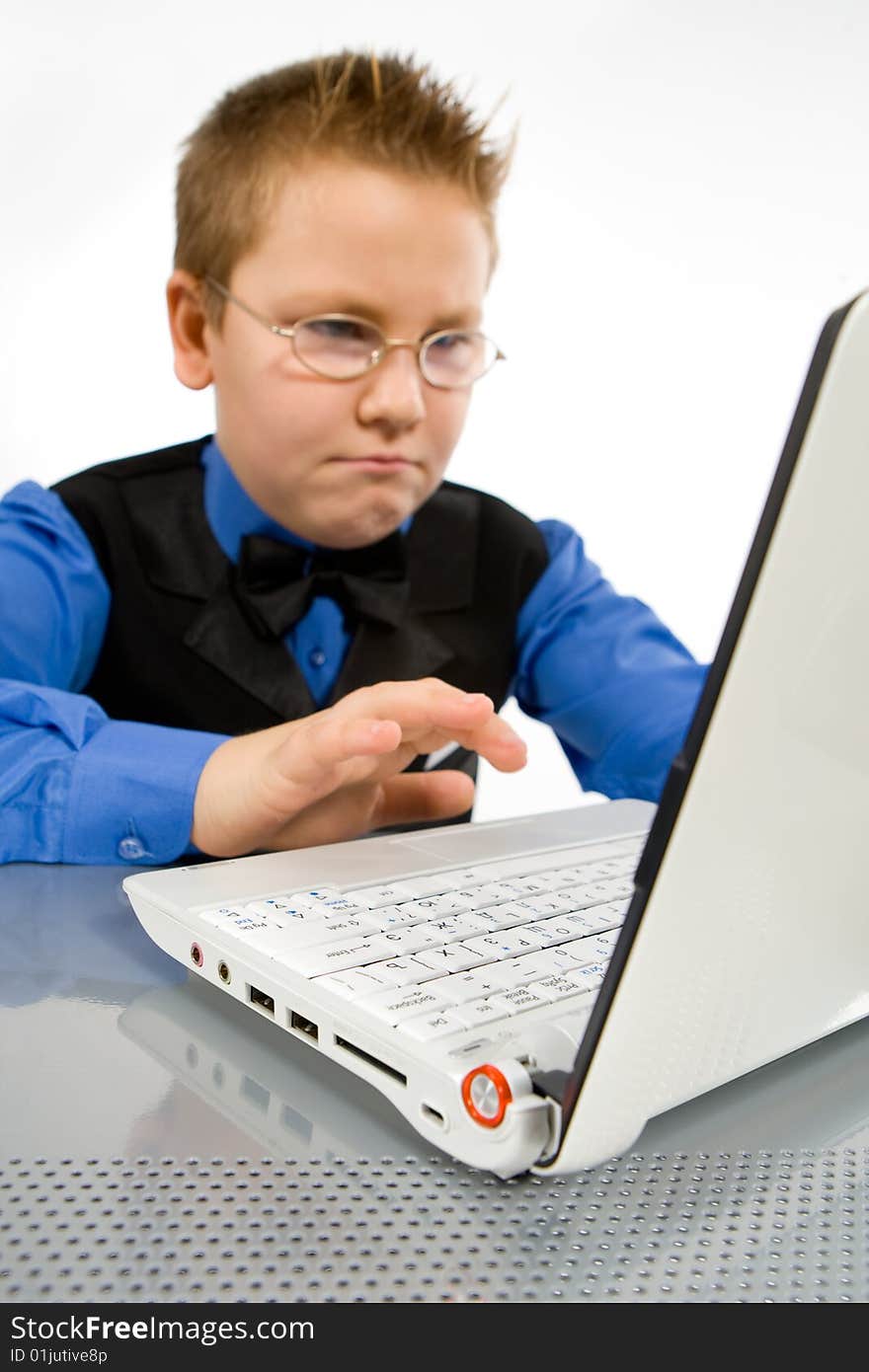 Funny school boy with laptop isolated on white