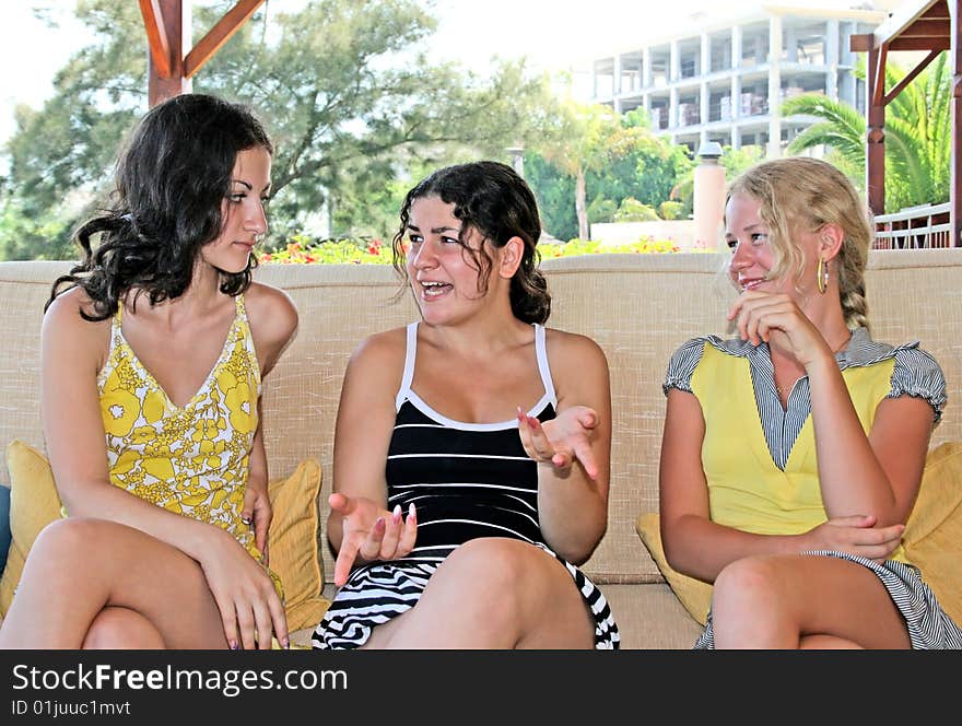 Pretty blond and brunette girls having fun on the sofa. Pretty blond and brunette girls having fun on the sofa.