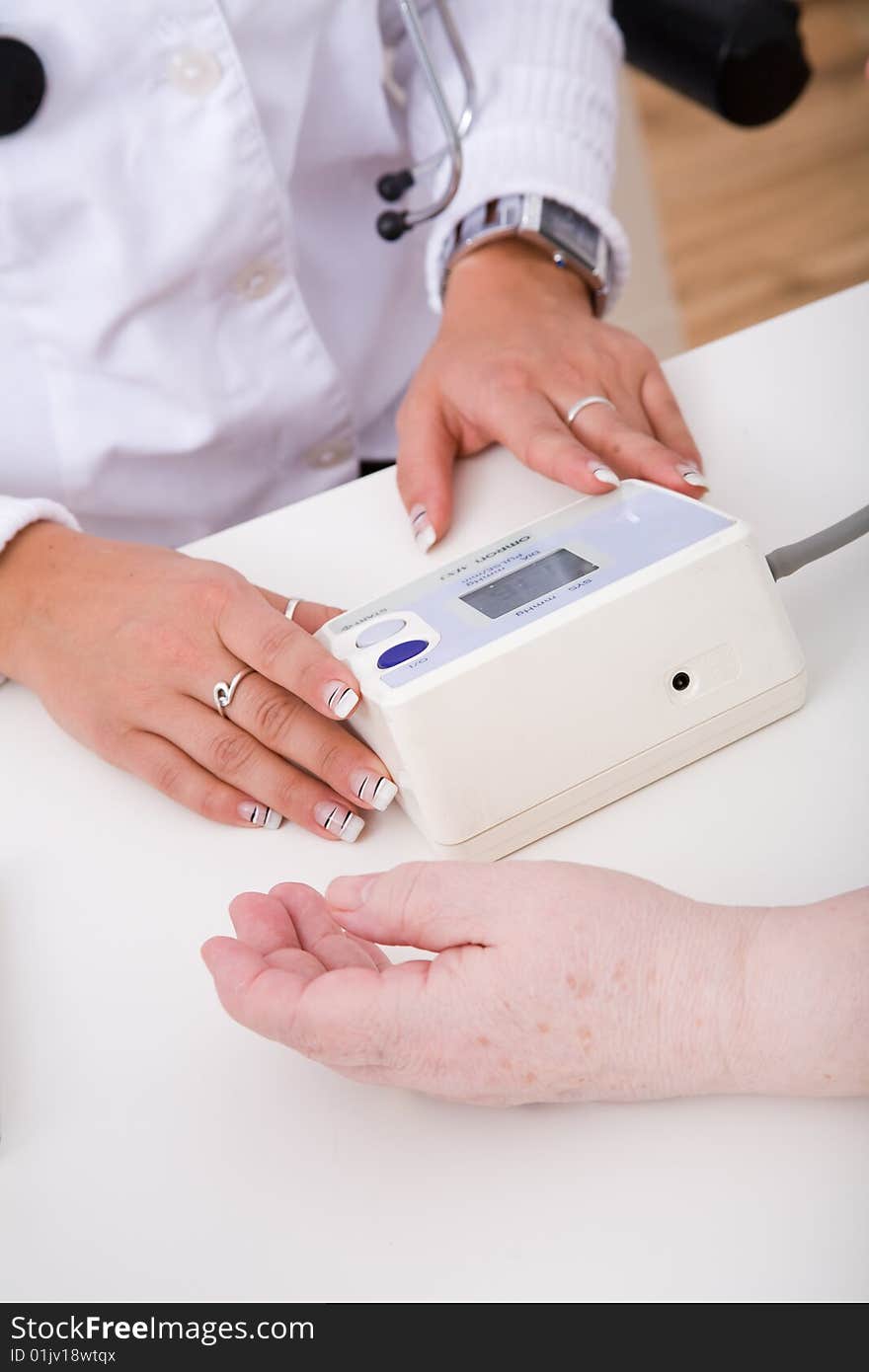 Doctor, patient and a blood pressure gauge