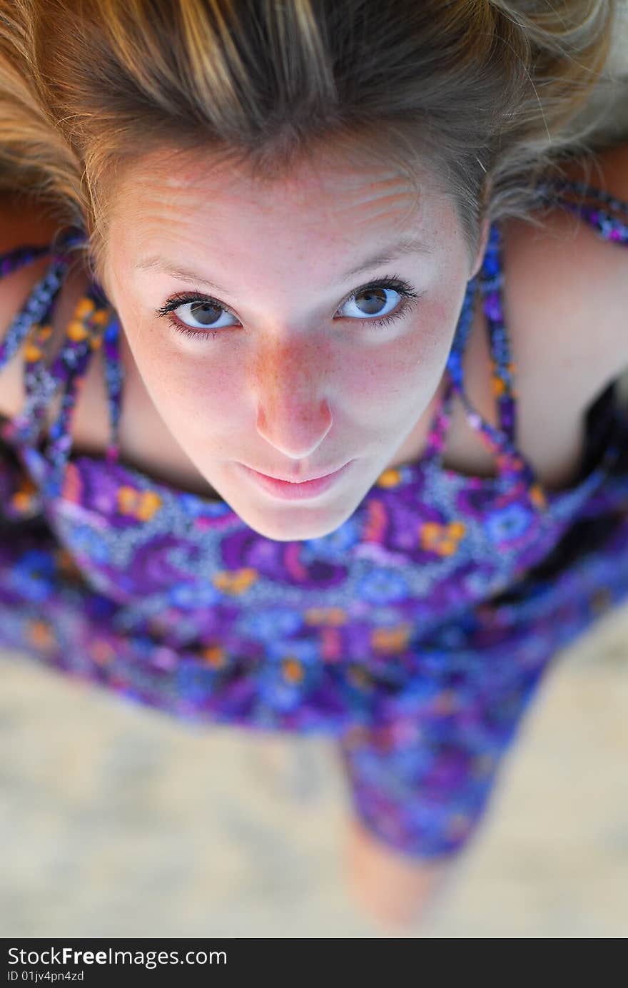 Face of beautiful young blond girl staring intensly into camera while laying down. Face of beautiful young blond girl staring intensly into camera while laying down