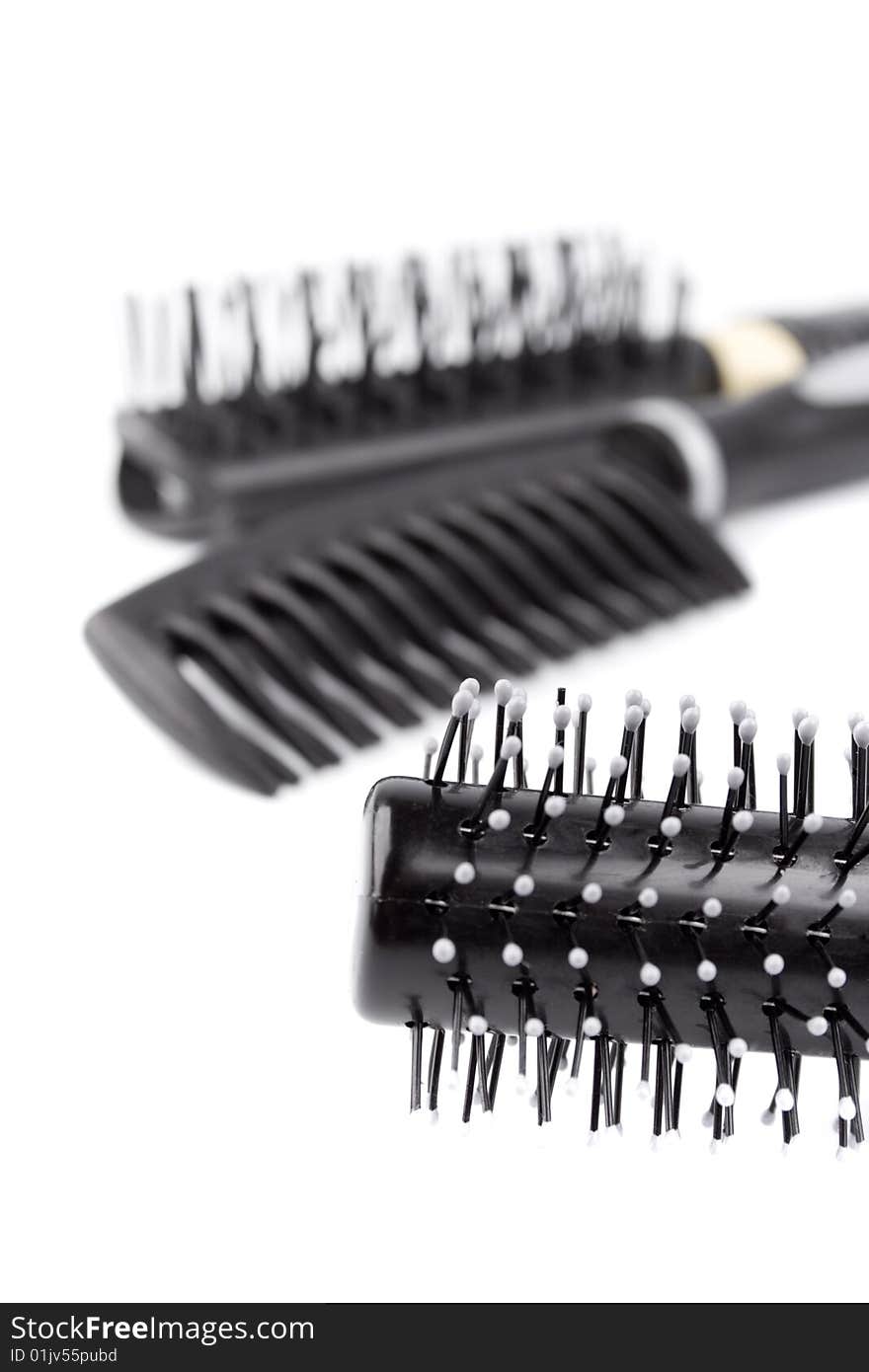 Three hairbrushes closeup on white background