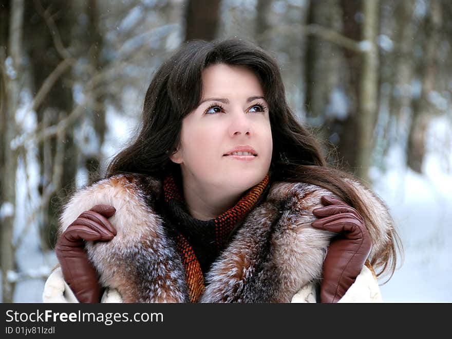 Portrait of a young girl in a fur coat in winter forest. Portrait of a young girl in a fur coat in winter forest.