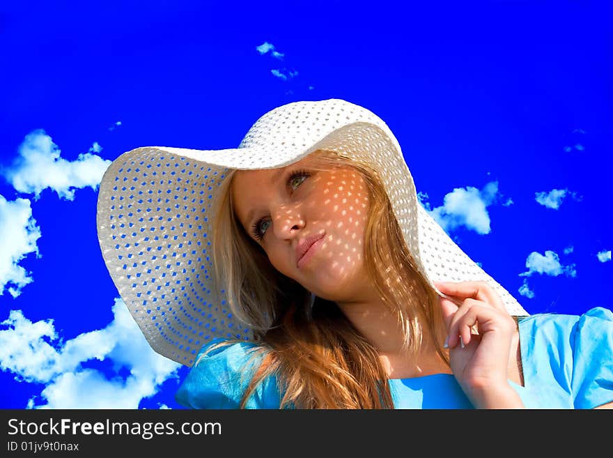 Young girl under hat in summer