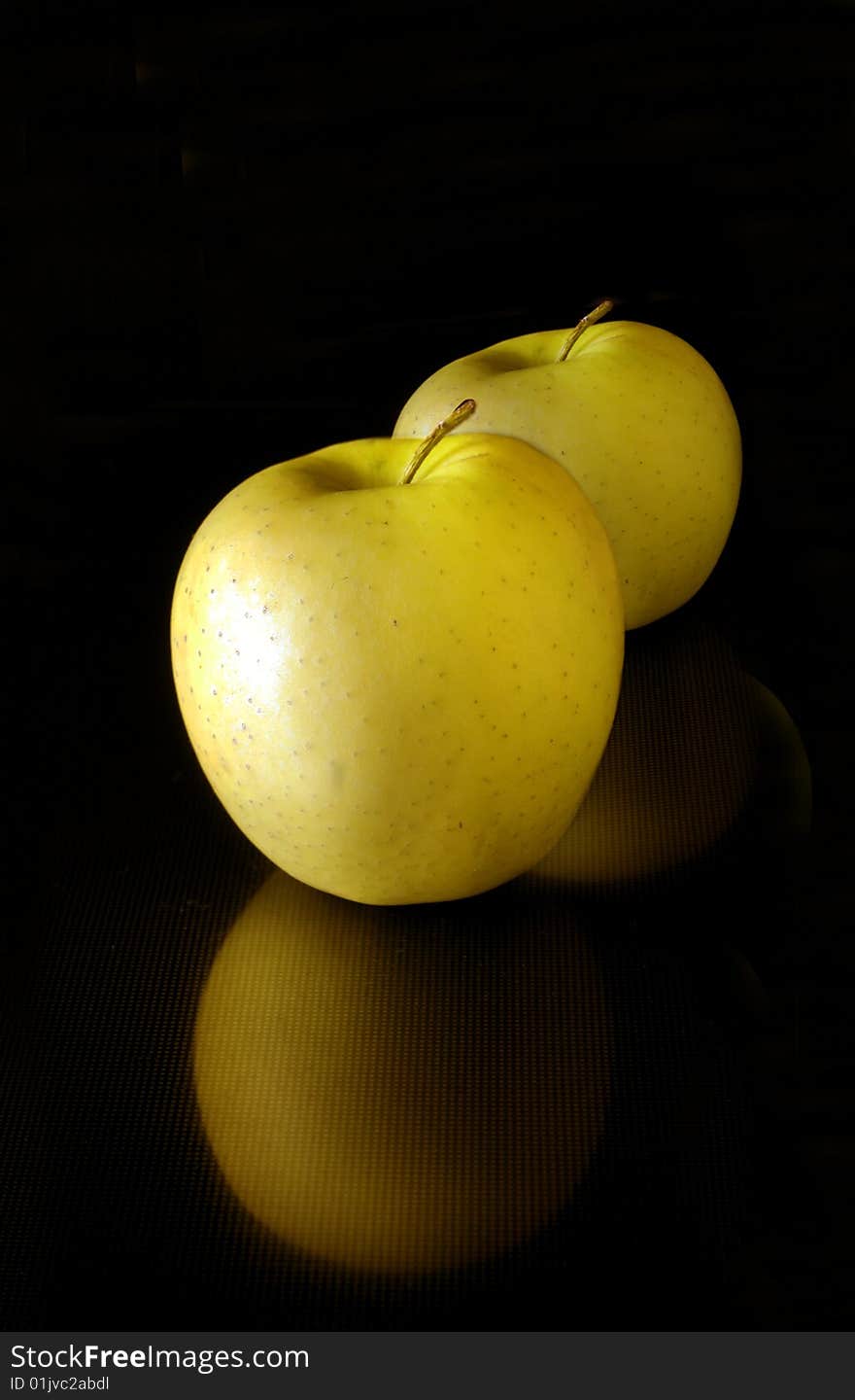 Apples on a black background with reflection