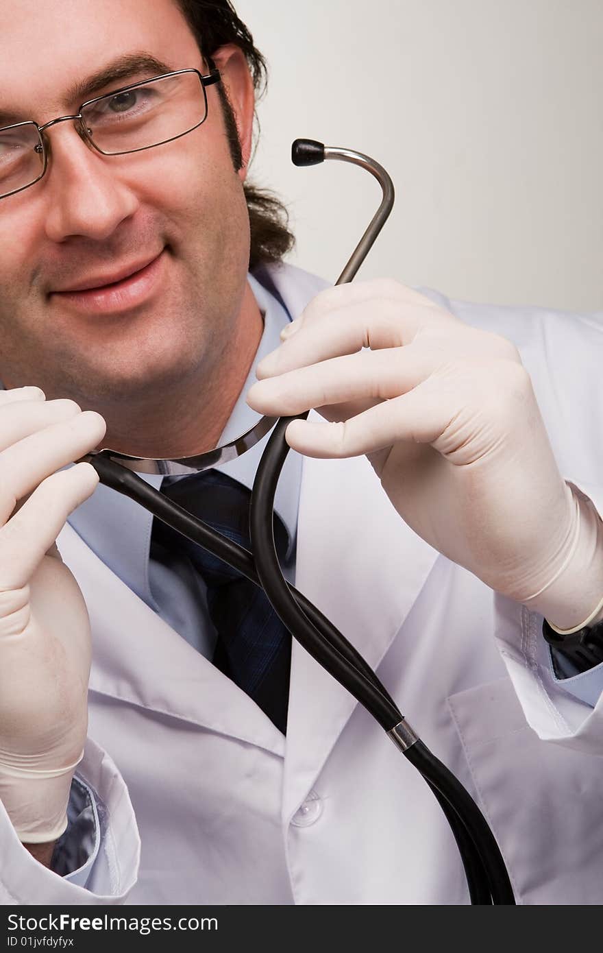 Smiling doctor with stethoscope over white. Smiling doctor with stethoscope over white