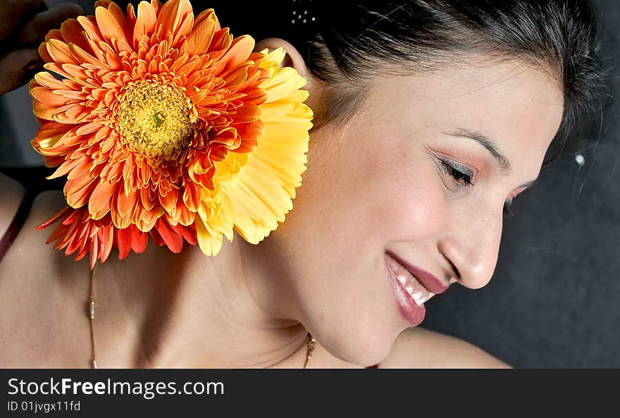 Girl with flower in studio.