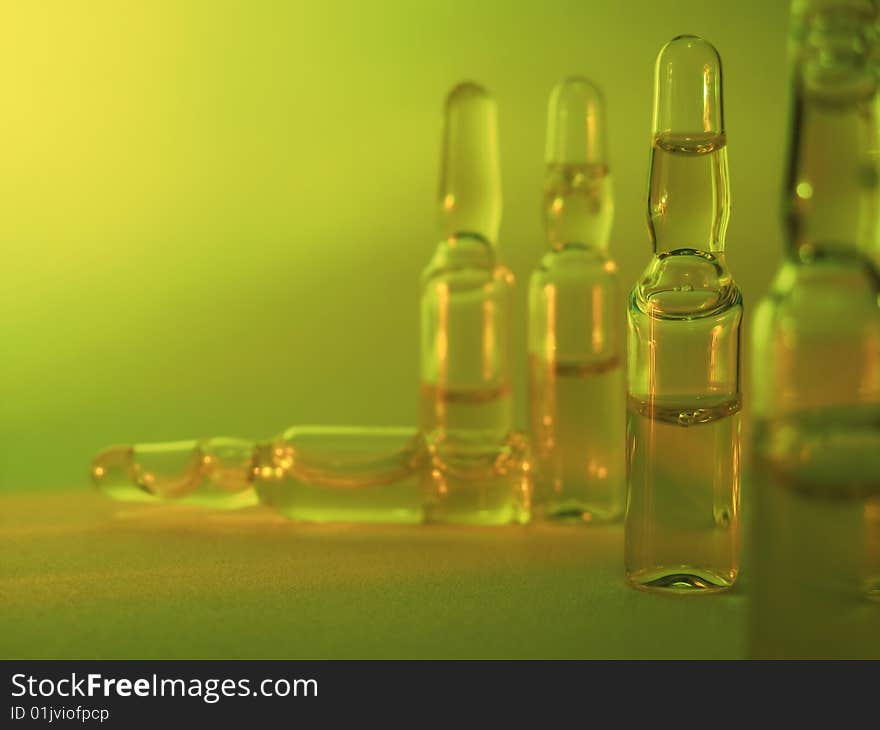 Colored vials on the green background