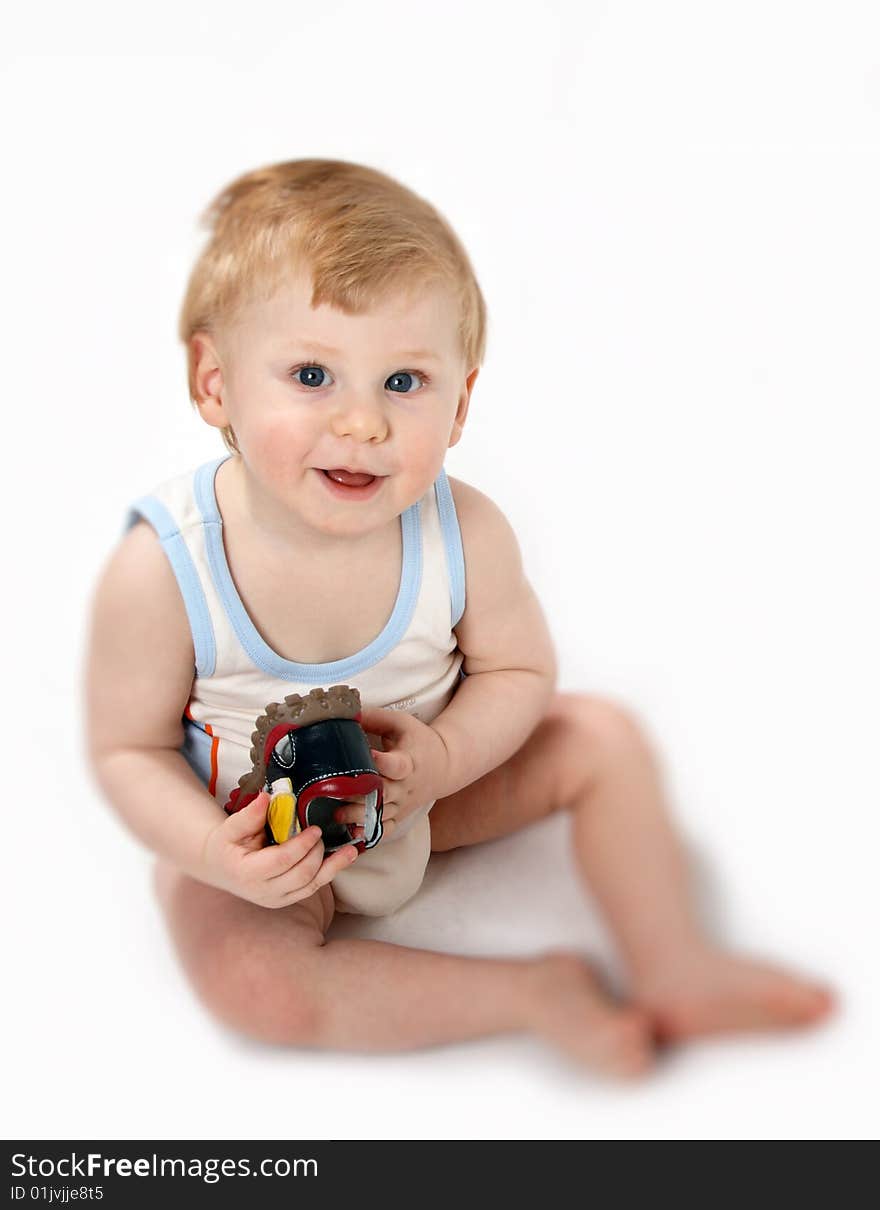 The beautiful little boy tries on footwear. The beautiful little boy tries on footwear