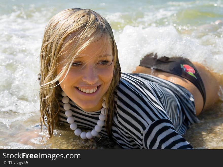 A young girl lay in the water. A young girl lay in the water