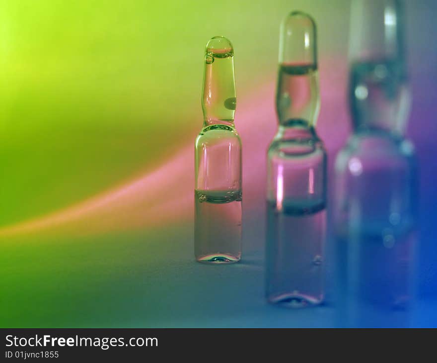 Colored vials on the green background