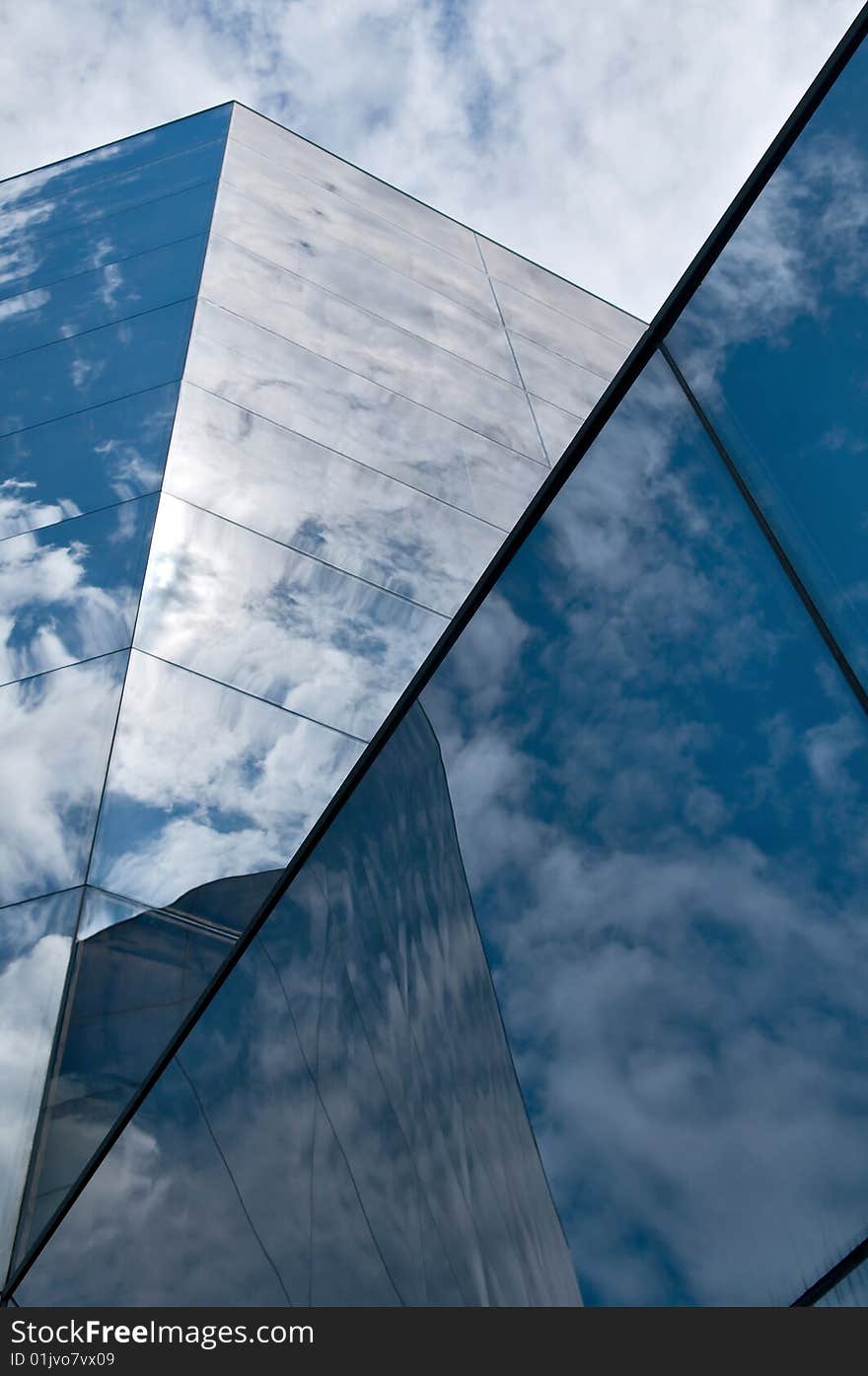 A part of an skyscrapper against a cloudy sky