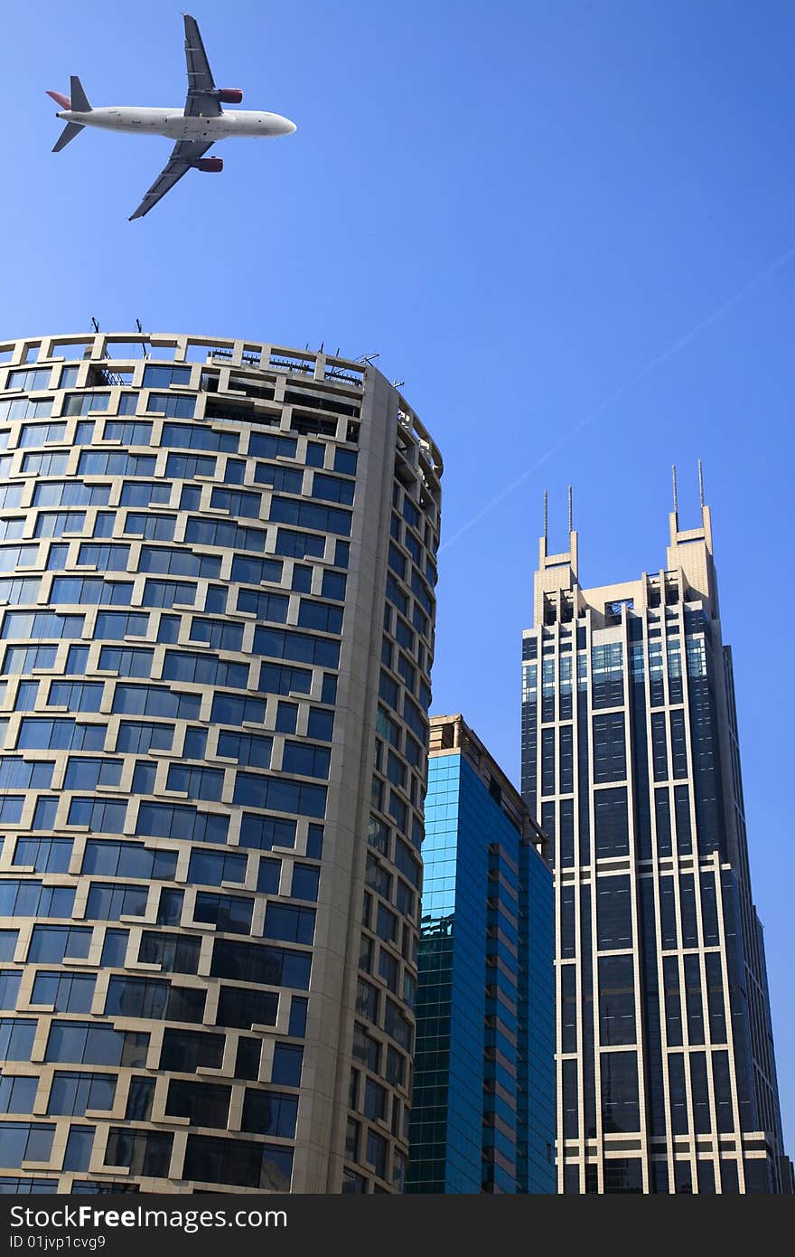 The airplene voyageing through the modern buildings of the lujiazui financial centre in shanghai china. The airplene voyageing through the modern buildings of the lujiazui financial centre in shanghai china.