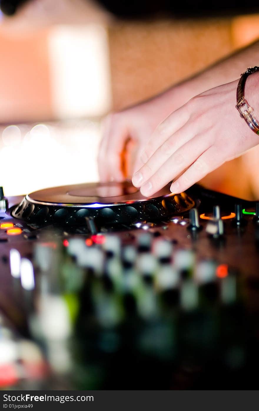 Close-up of deejays hand and turntable