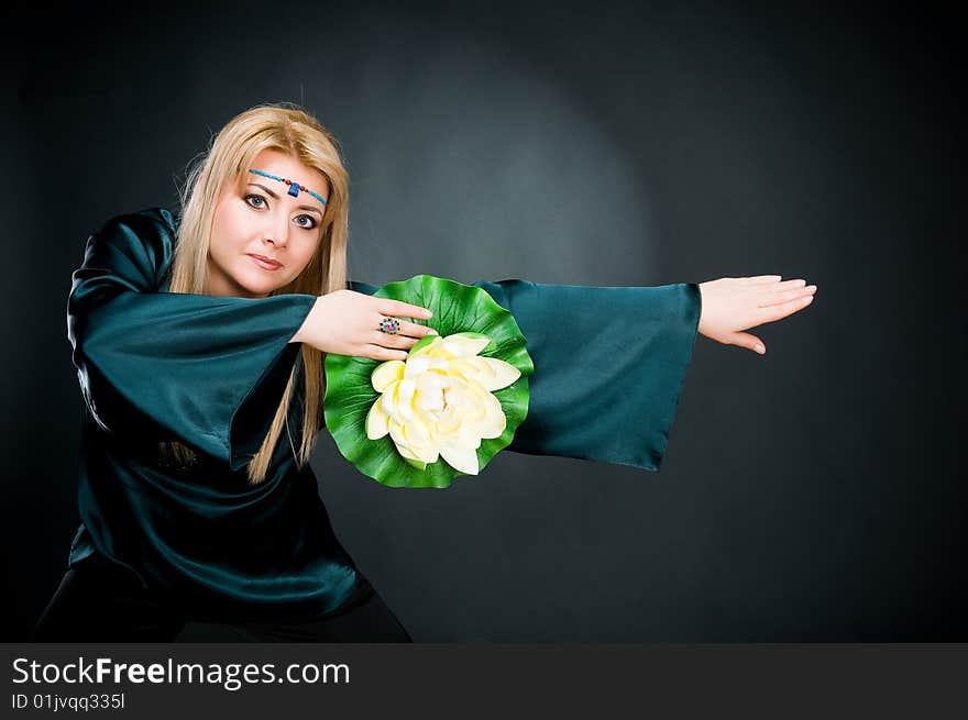 Woman with lotus, studio shot