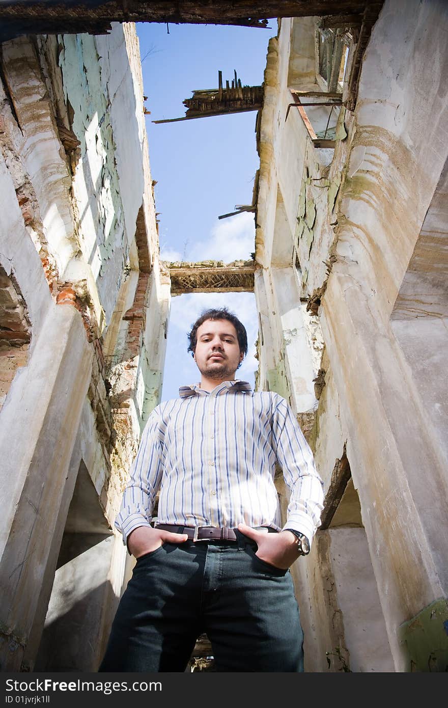 Young stylish man in abandoned building, low angle of view