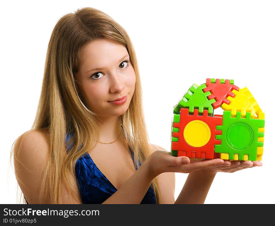 Beautiful girl with a toy house in the hands