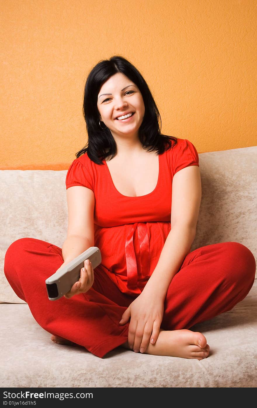 Beautiful Pregnant Woman Sitting On The Couch