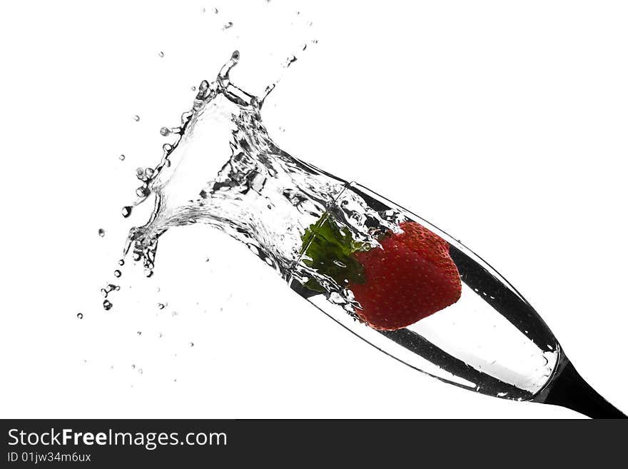 Red strawberry splash in water glass against white background. Red strawberry splash in water glass against white background