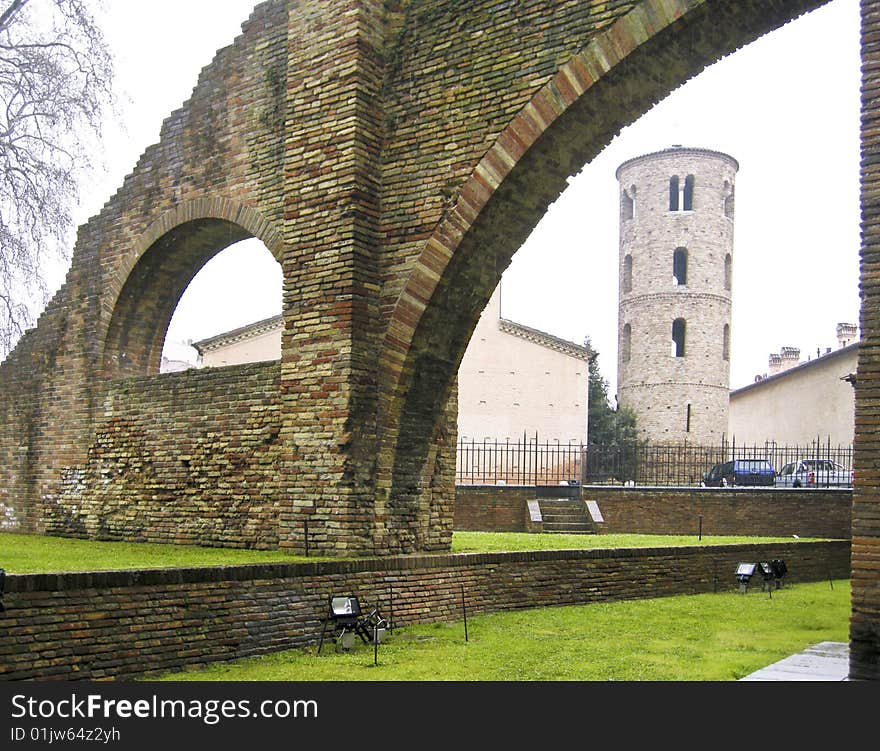 External walls of the Byzantine cathedral of Saint Apollinare and Medieval bell tower in the background, in Ravenna, Italy. External walls of the Byzantine cathedral of Saint Apollinare and Medieval bell tower in the background, in Ravenna, Italy.