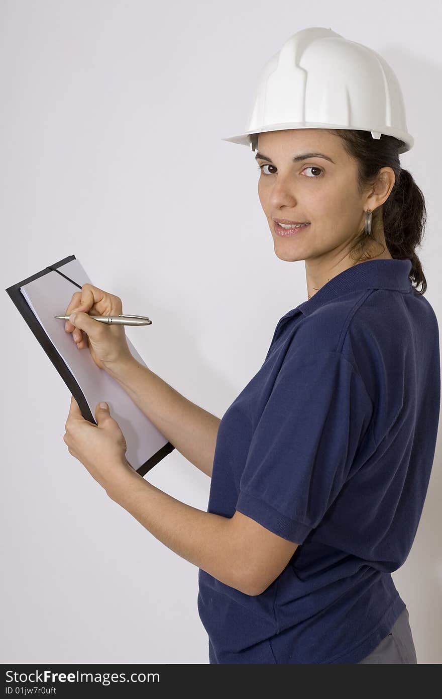 Young female engineer calculating with papers in her hand