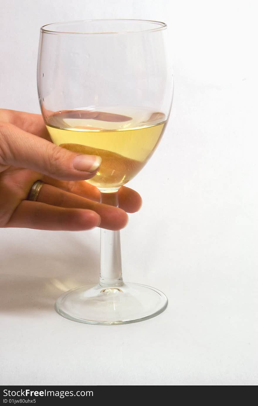 Picking up a glass of white wine. Picking up a glass of white wine