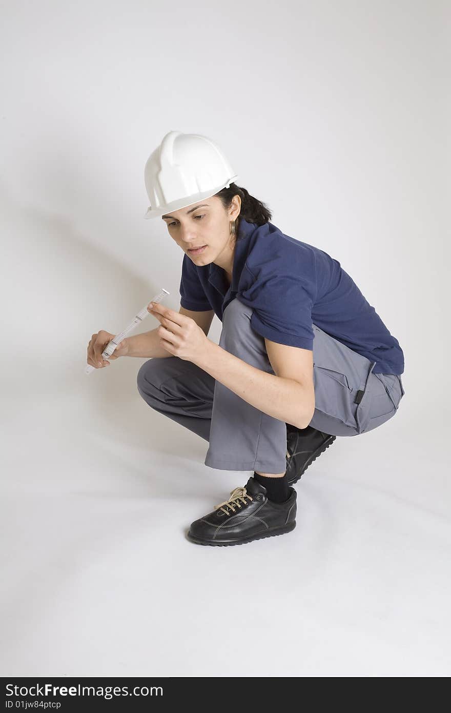 Young female engineer calculating with papers in her hand