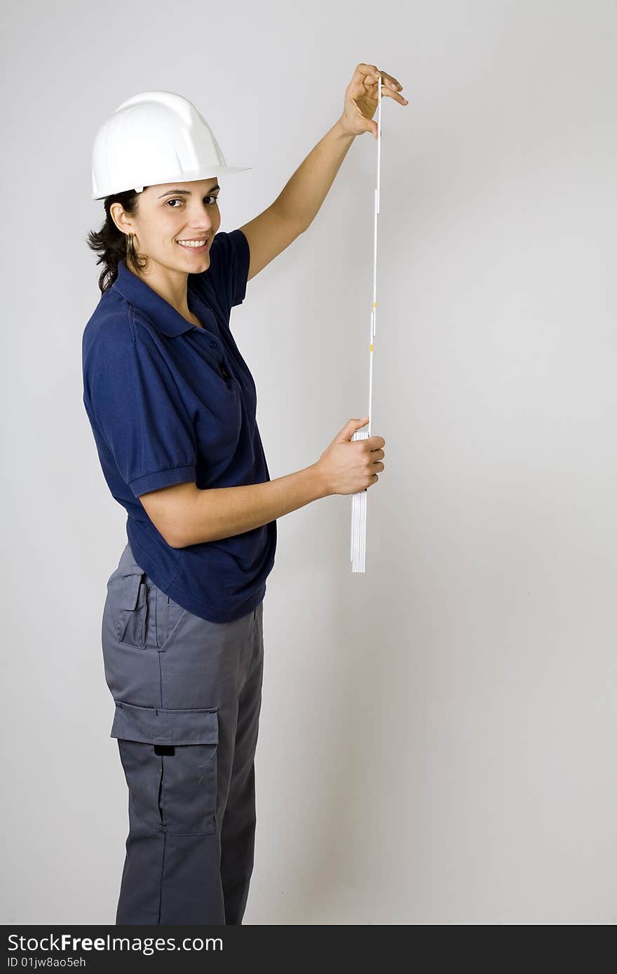 Young female engineer calculating with papers in her hand