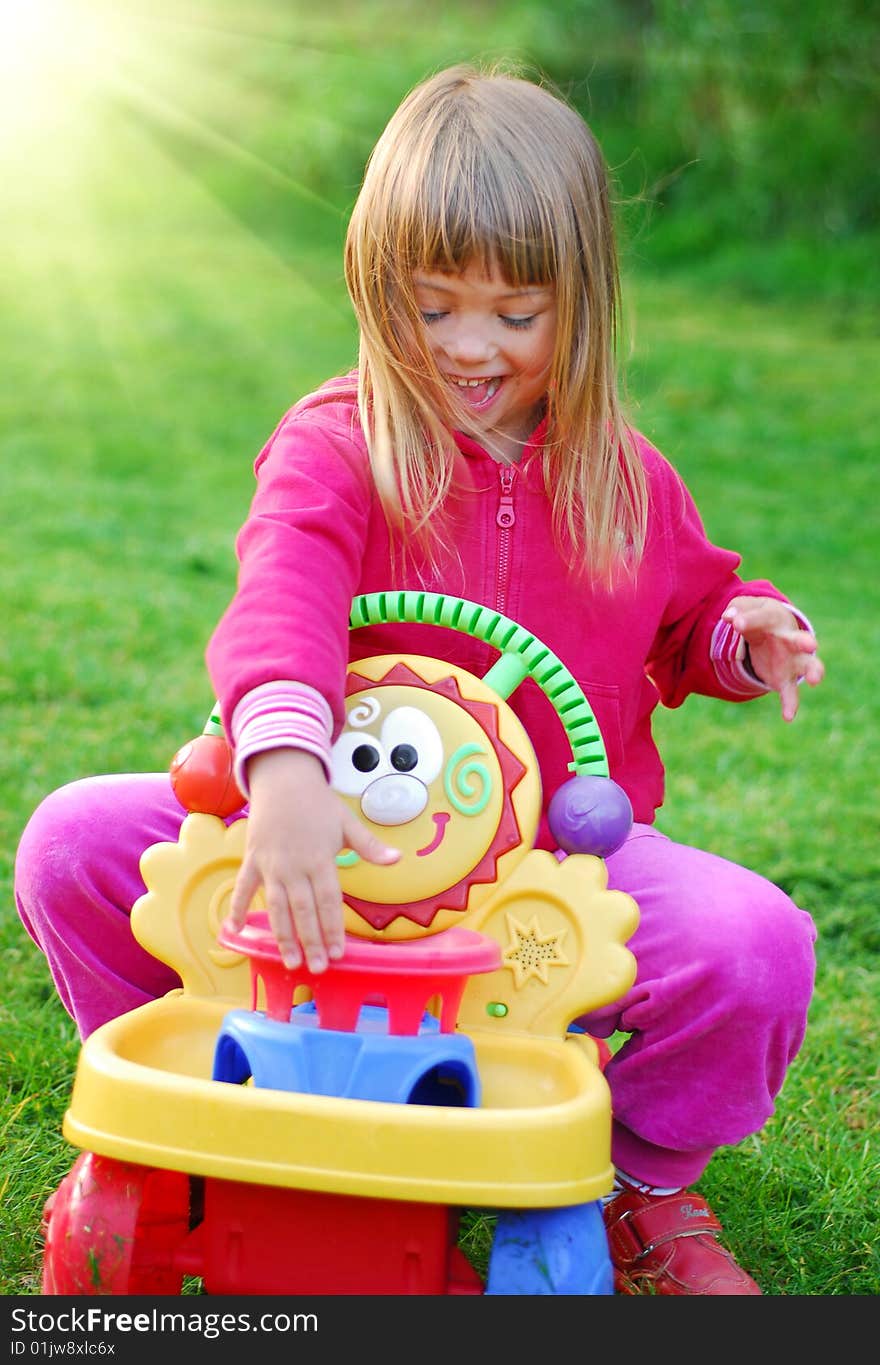 Little girl playing in the garden. Little girl playing in the garden