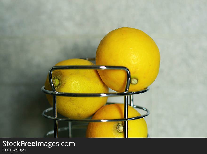 Three lemons against a gray background. Three lemons against a gray background