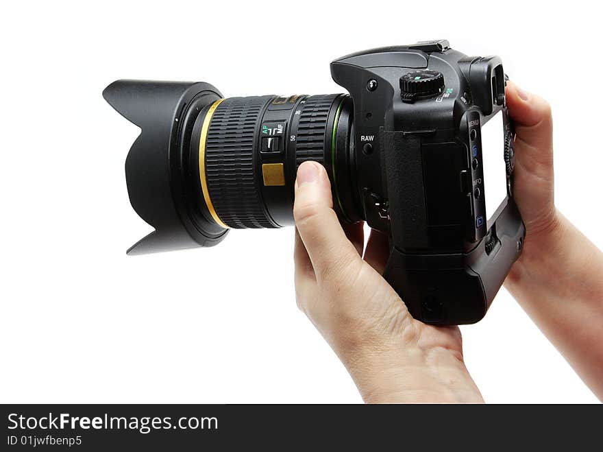 Black digital camera in hands isolated on white