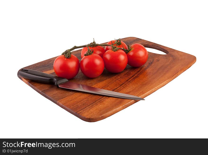 Tomatoes and knife on cutting board