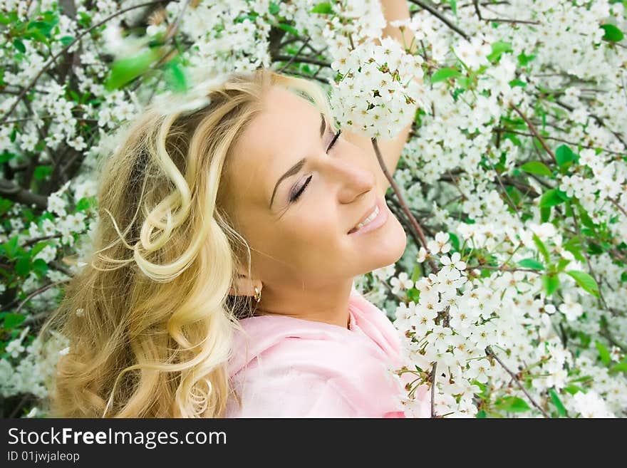 Blonde girl and cherry flowers in spring. Blonde girl and cherry flowers in spring