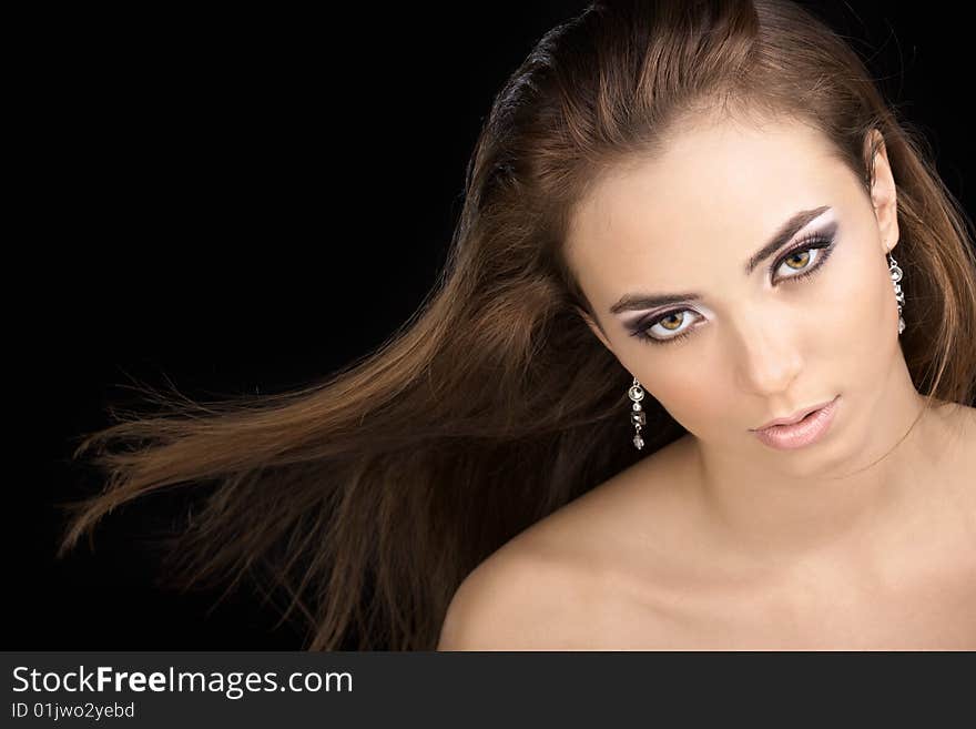 The beautiful woman with a flying hair on a black background. The beautiful woman with a flying hair on a black background