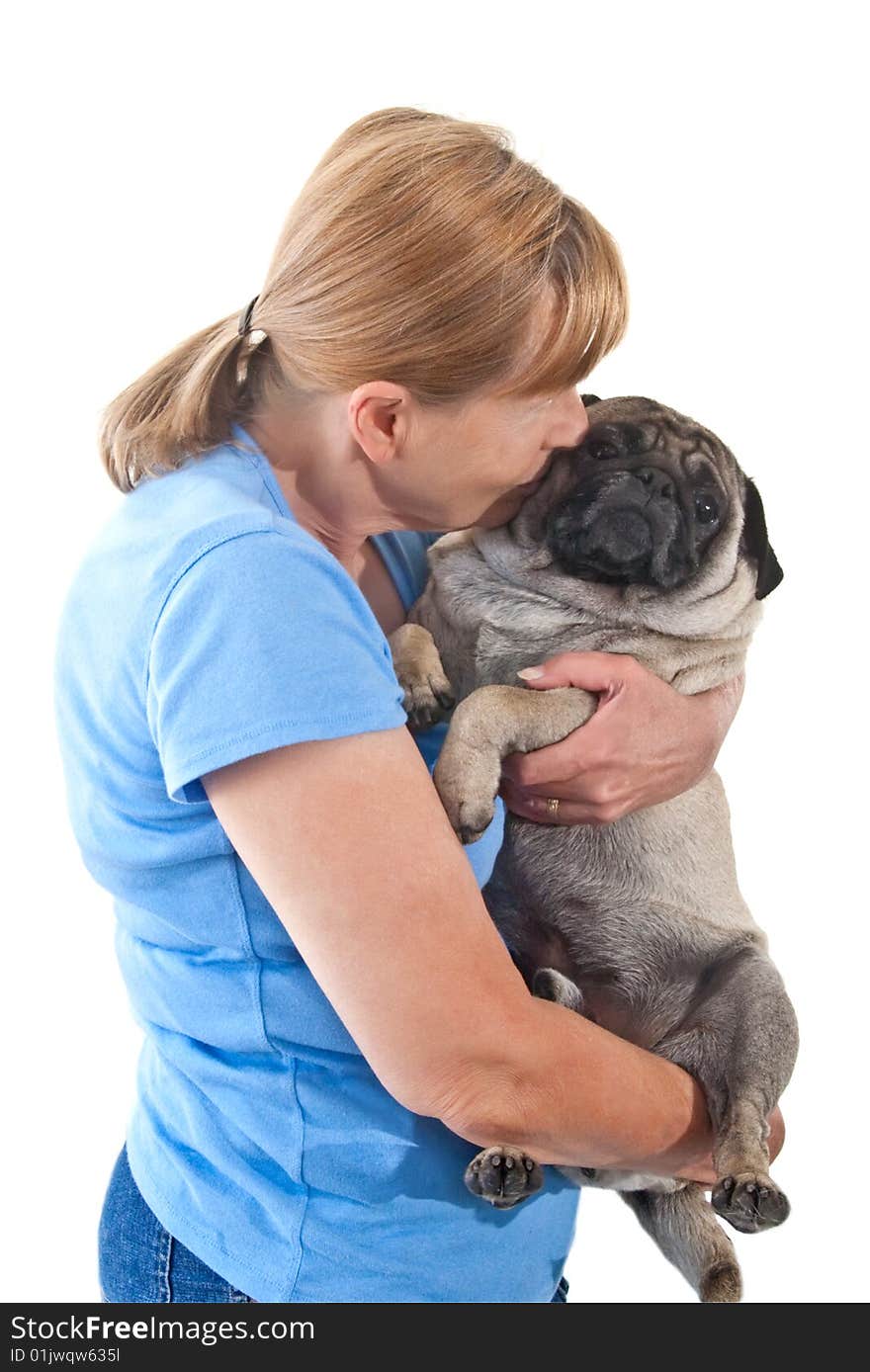 Mature Lady Cuddling a Pug Dog, Isolated on a White Background. Mature Lady Cuddling a Pug Dog, Isolated on a White Background