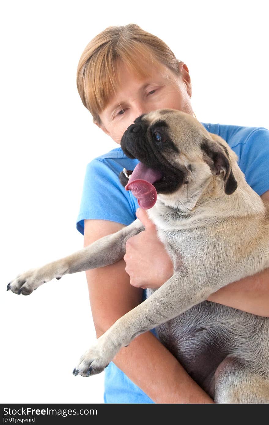 Mature Lady Cuddling a Female Pug Dog with Tongue Stuck WAY Out, Isolated on a White Background. Mature Lady Cuddling a Female Pug Dog with Tongue Stuck WAY Out, Isolated on a White Background