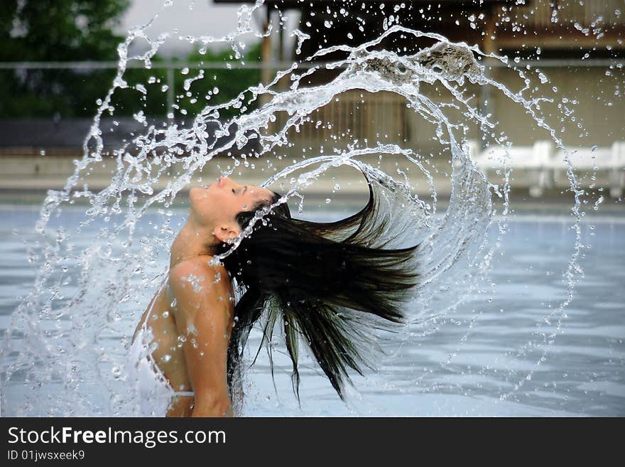 Woman And Arcs Of Water In Pool