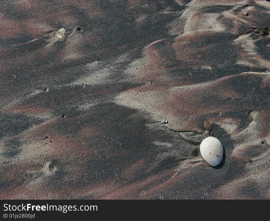 Colored sand. Ocean beach, Namibia.