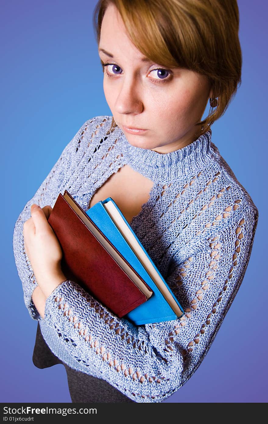 Young naive girl holding a books