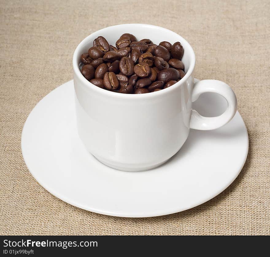 Coffee beans in white cup. Coffee beans in white cup