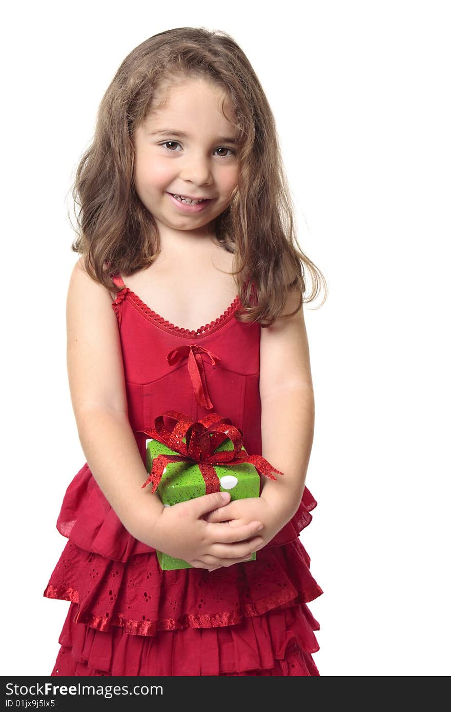 Little girl in a red dress holds a green and red present and smiles sweetly. Little girl in a red dress holds a green and red present and smiles sweetly.