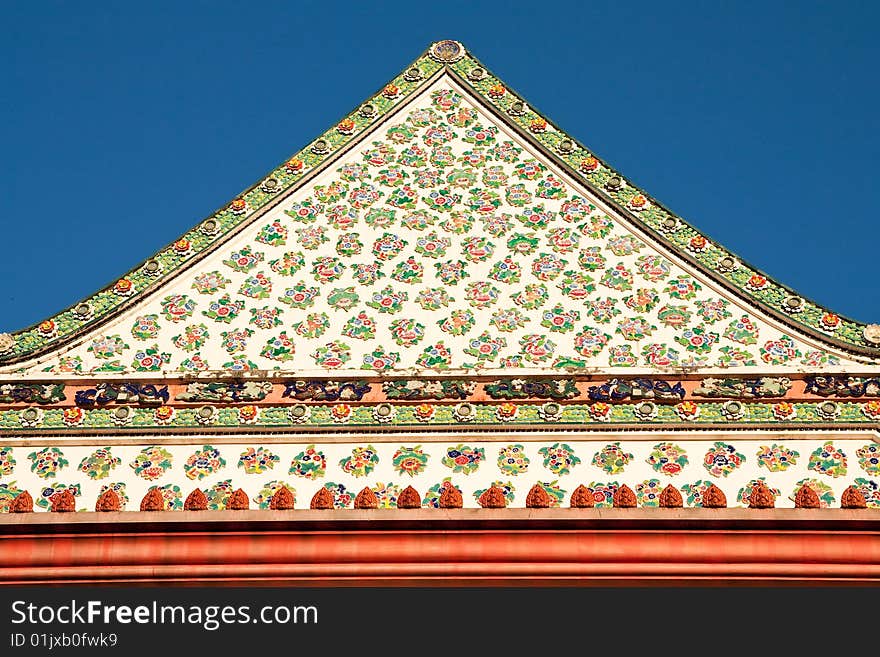 Traditional Thai art of mosaic decoration on top front of Buddhist church, Bangkok, Thailand. Traditional Thai art of mosaic decoration on top front of Buddhist church, Bangkok, Thailand