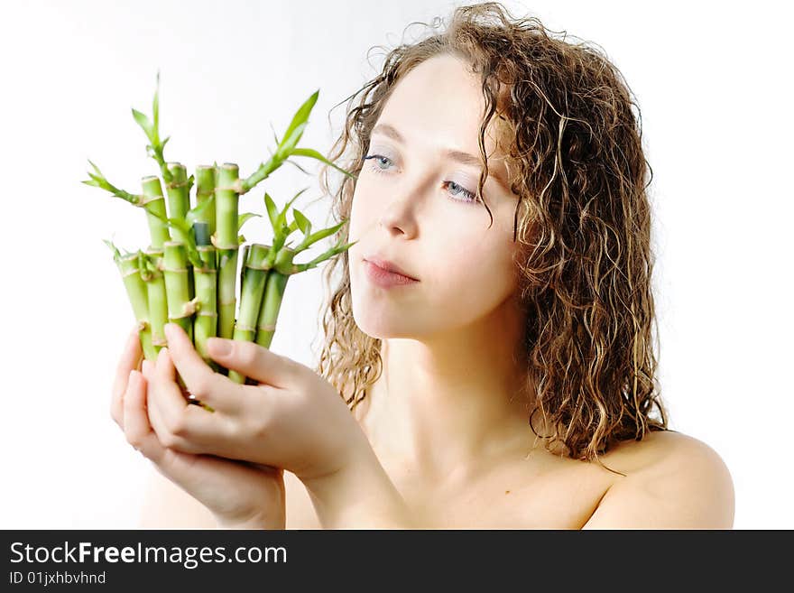 An image of a woman looking at bamboo in her hands. An image of a woman looking at bamboo in her hands