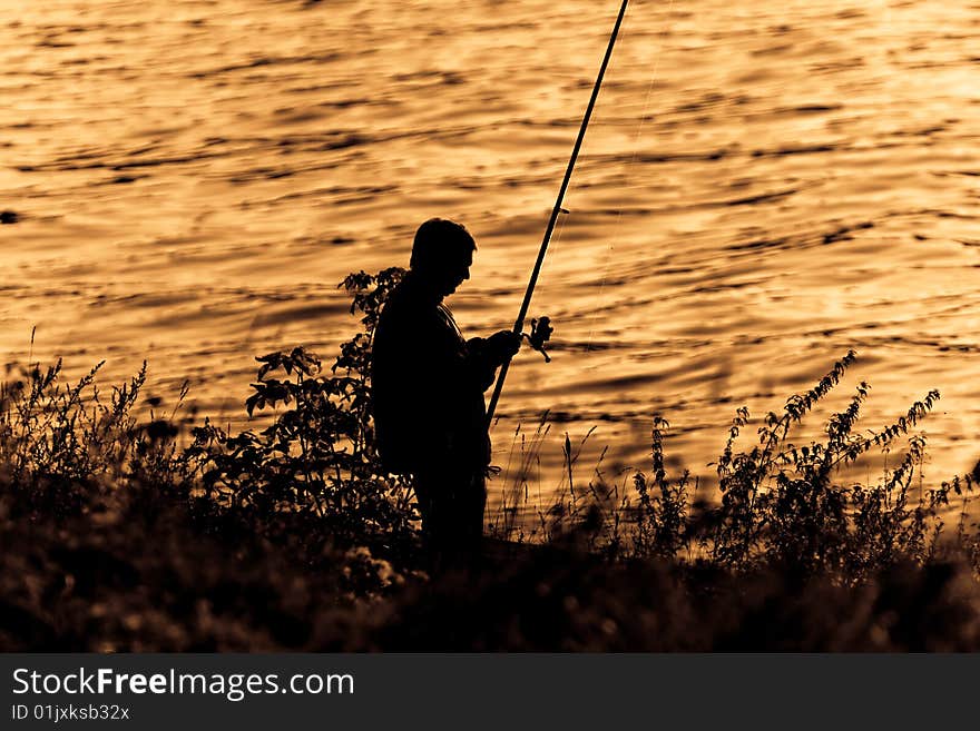 Silhouette of Fisherman on sunset. Silhouette of Fisherman on sunset.