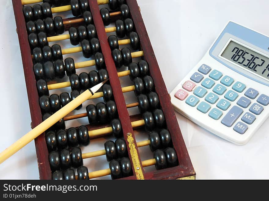 Traditional Chinese calculation tool-Abacus with a brush and a calculator. Traditional Chinese calculation tool-Abacus with a brush and a calculator