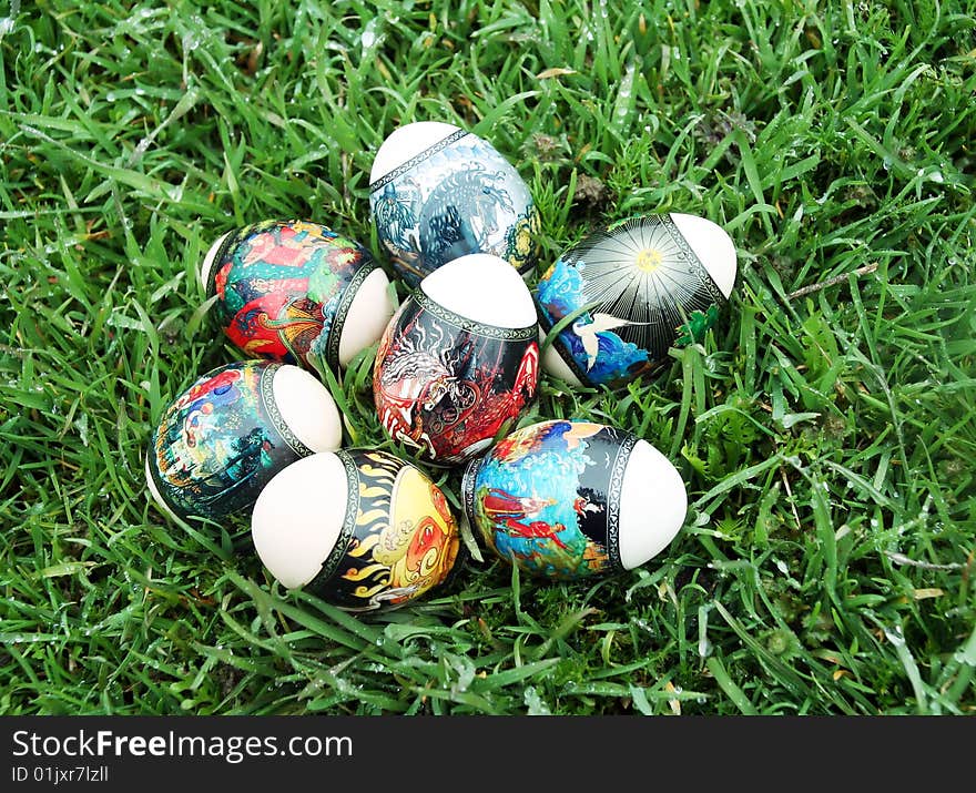 On a green grass Easter eggs lie