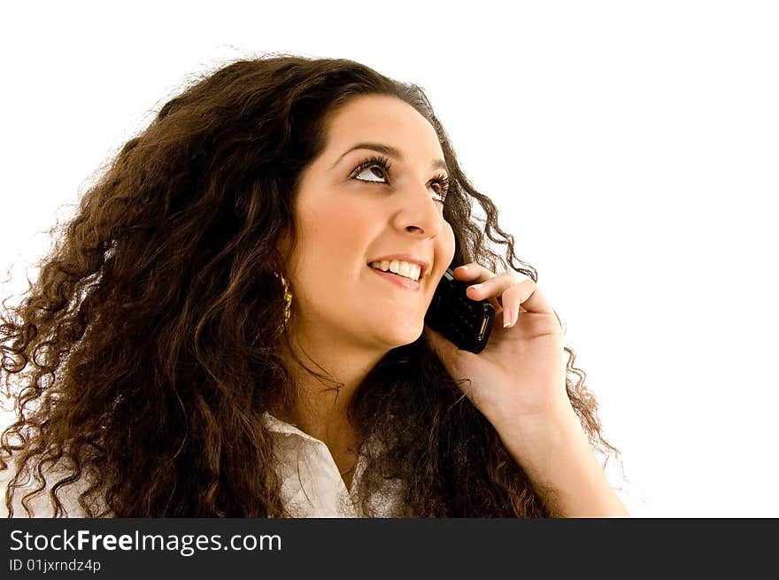 Latin american woman talking on phone on an isolated background