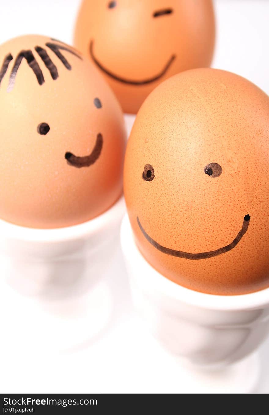 Eggs with a smiling faces on white background