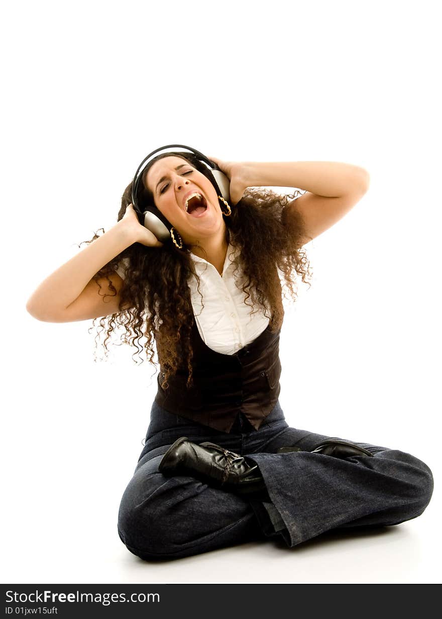 Young woman listening to music wih headphones on an isolated background