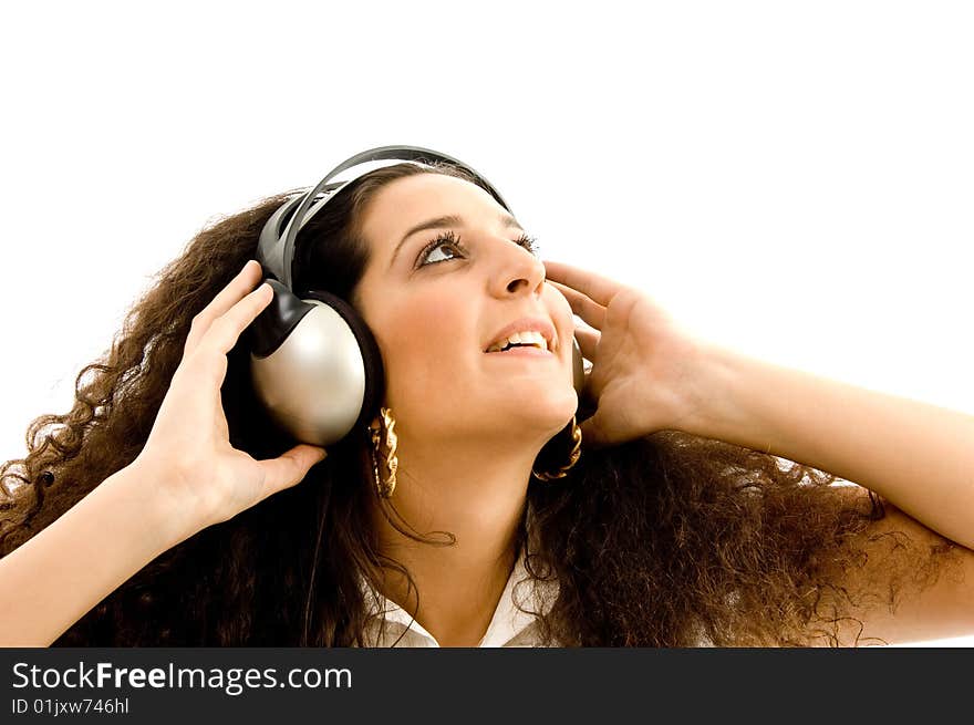 Beautiful female enjoying music against white background