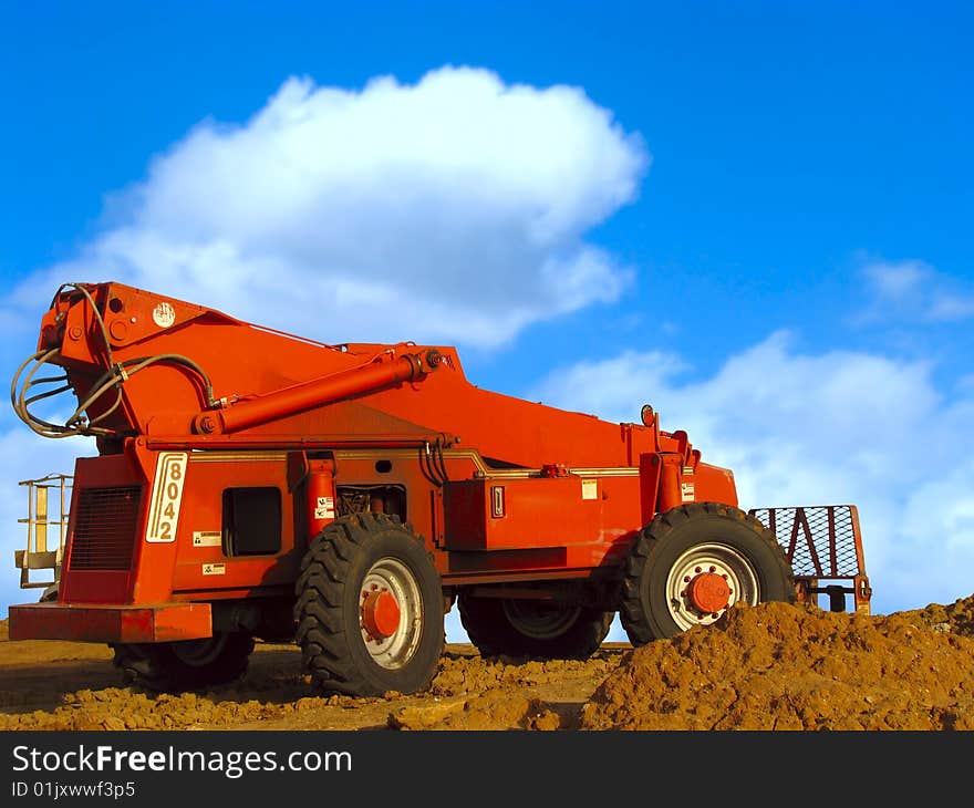 Bulldozer in action under blue sky. Bulldozer in action under blue sky.